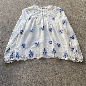White and blue patterned blouse